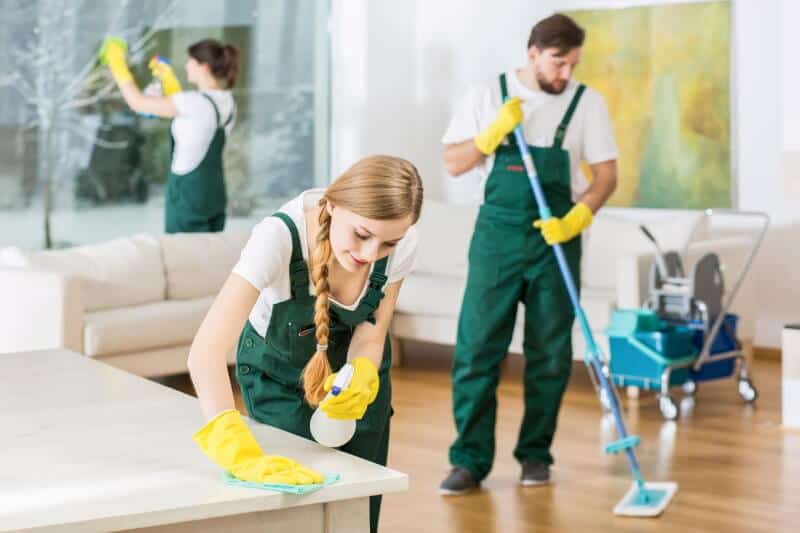 Professional cleaning crew cleaning a room