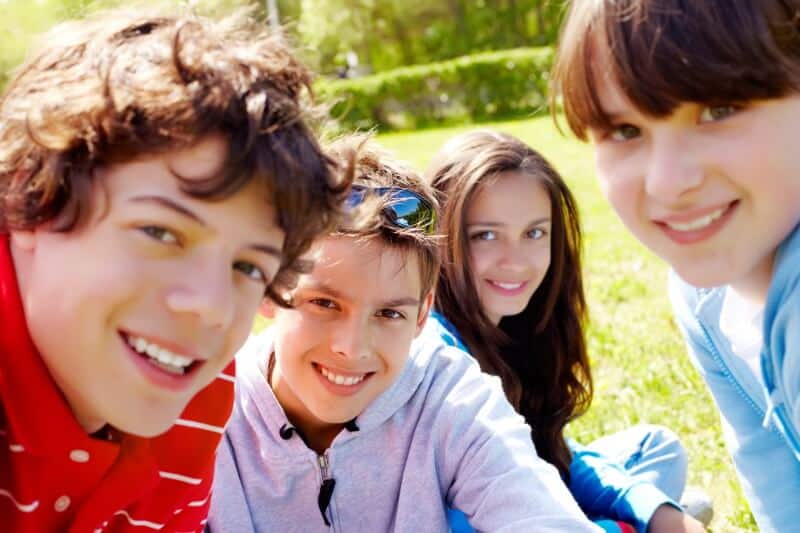 Four teenagers smiling
