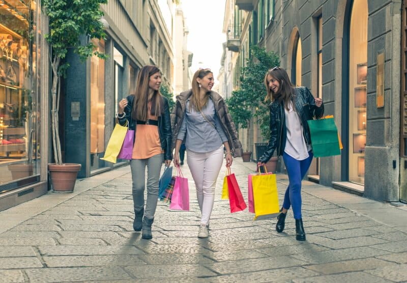 Three women carrying shopping bags