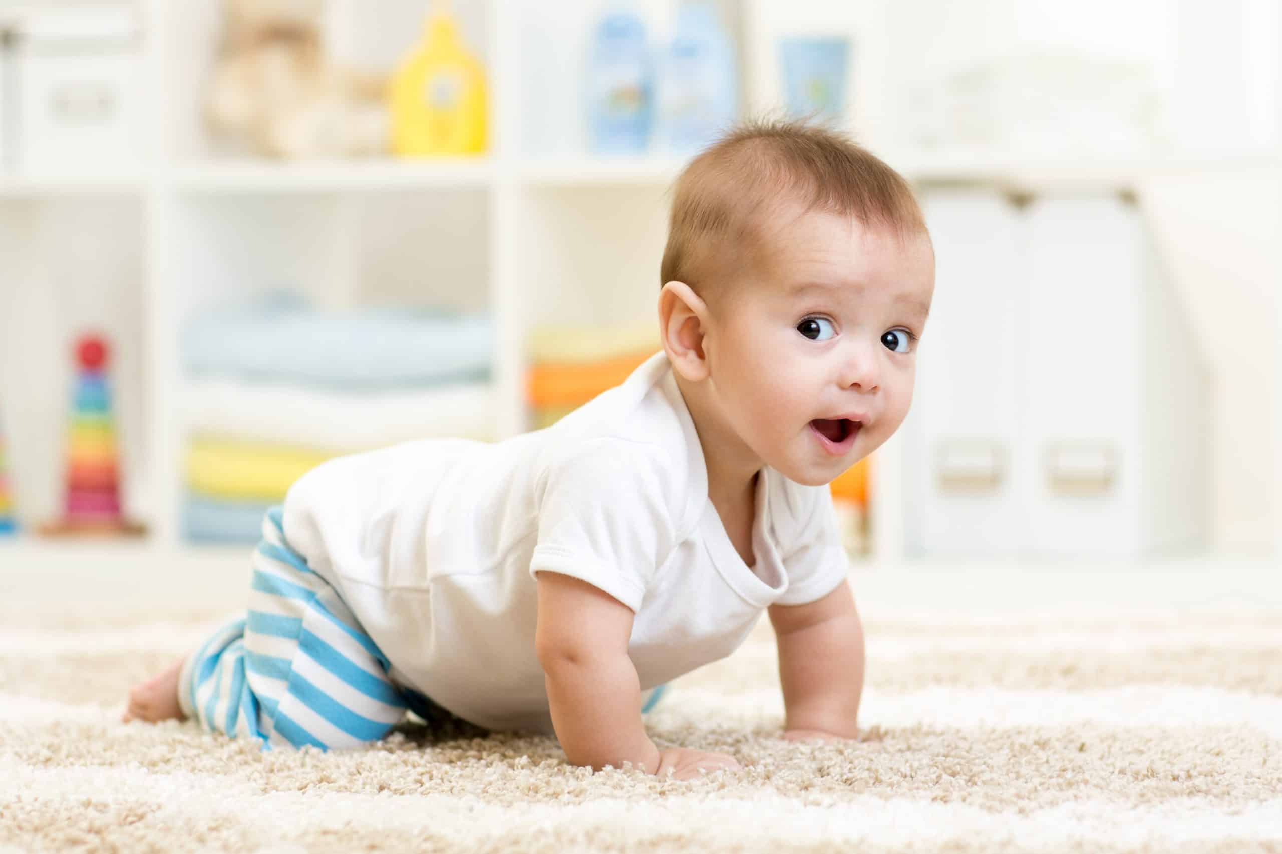 Baby crawling on a carpeted floor